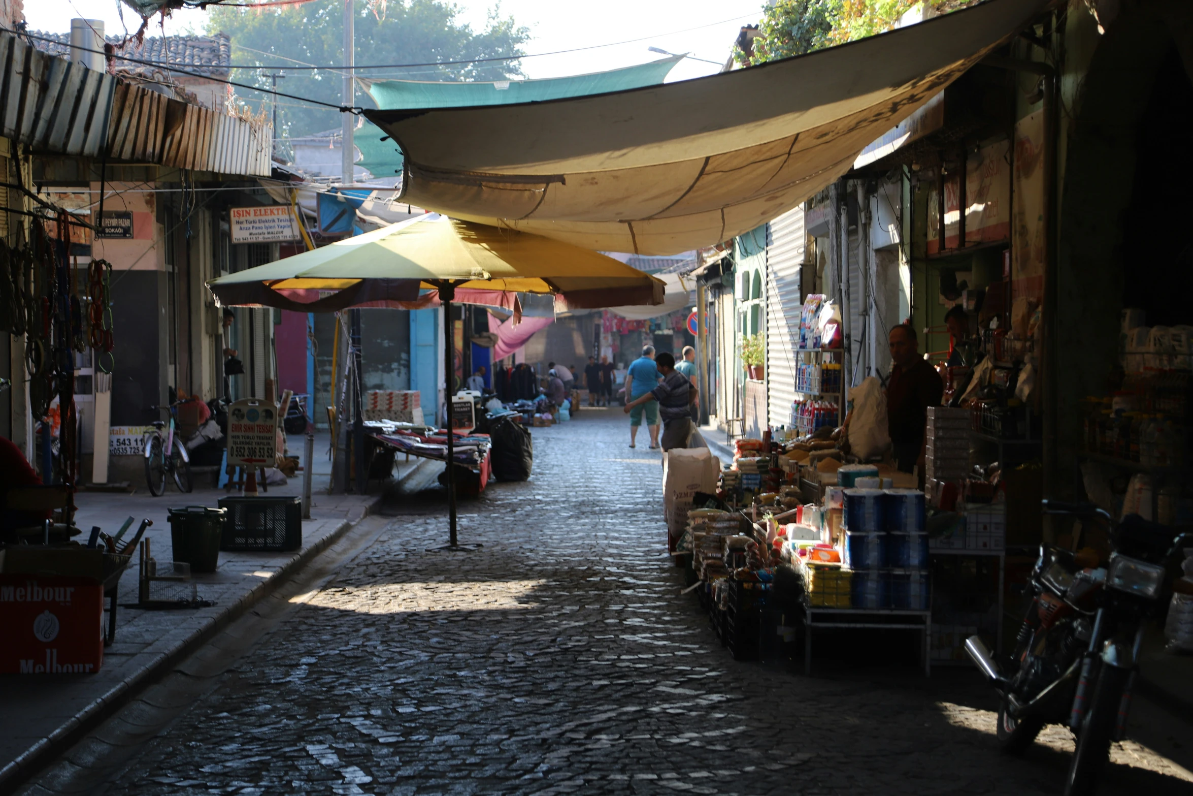 this is an empty street with umbrellas above