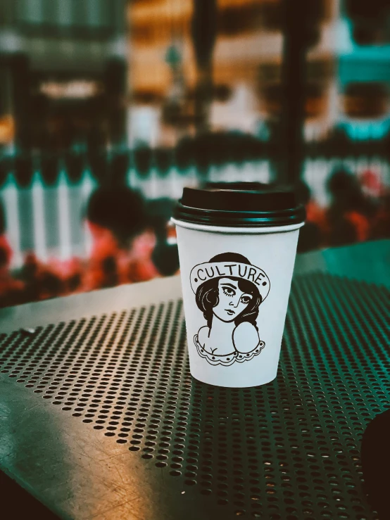 a coffee cup sitting on top of a table