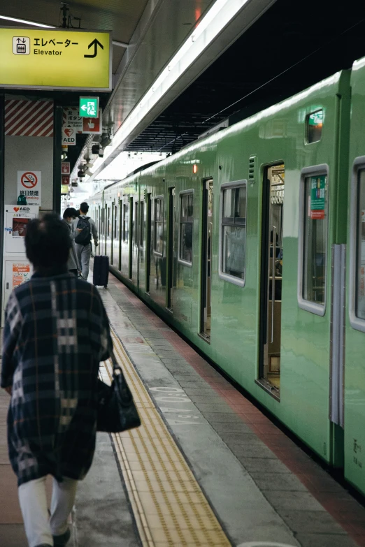 people walking down the walkway next to a train