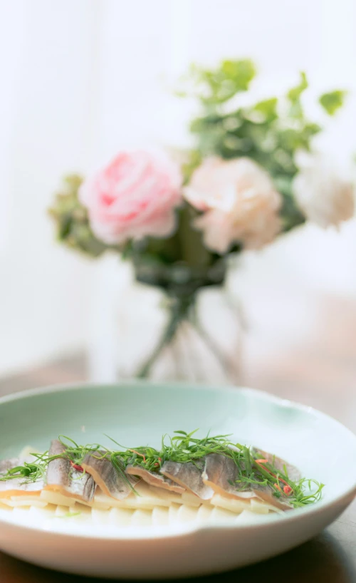 a plate filled with fish and vegetables on top of a table