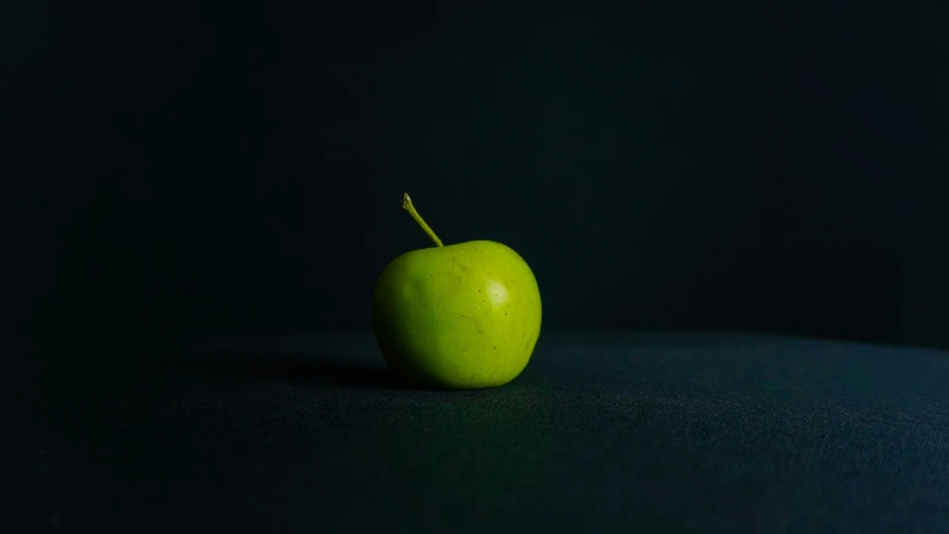 an apple is sitting still on the table