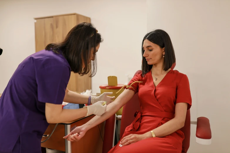 woman in red gown and white rubber gloves in an office