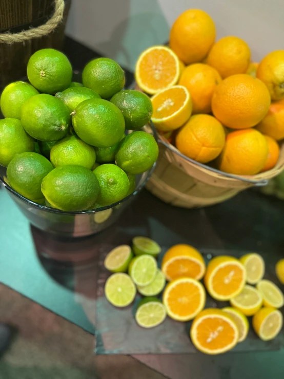 lemons and limes next to each other in a bucket