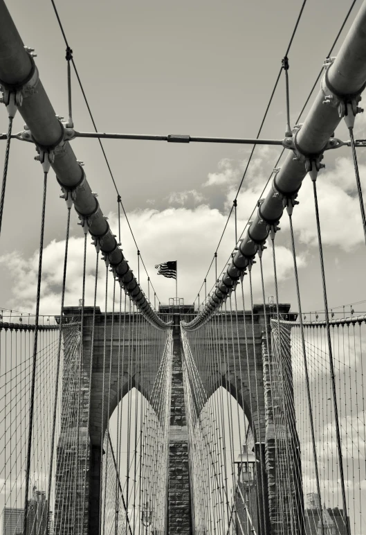 black and white pograph of bridge taken through an overhead wire