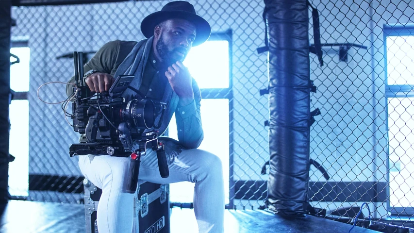 a man sitting in a room holding a camera