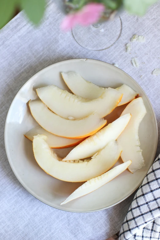 pieces of apple in a white bowl on a table