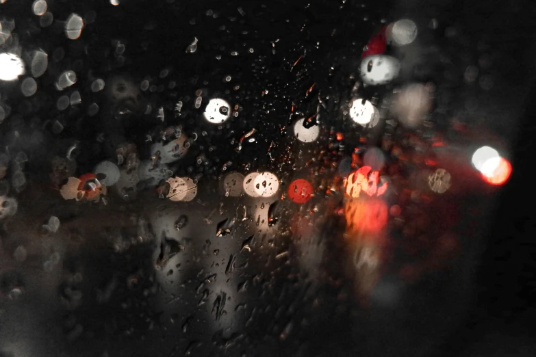 cars are driving on a wet road at night