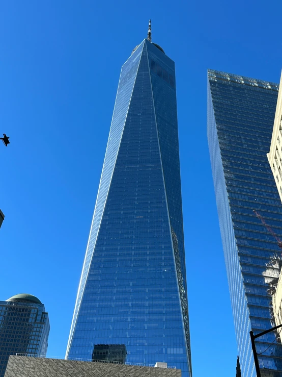 two tall buildings with blue sky in the background