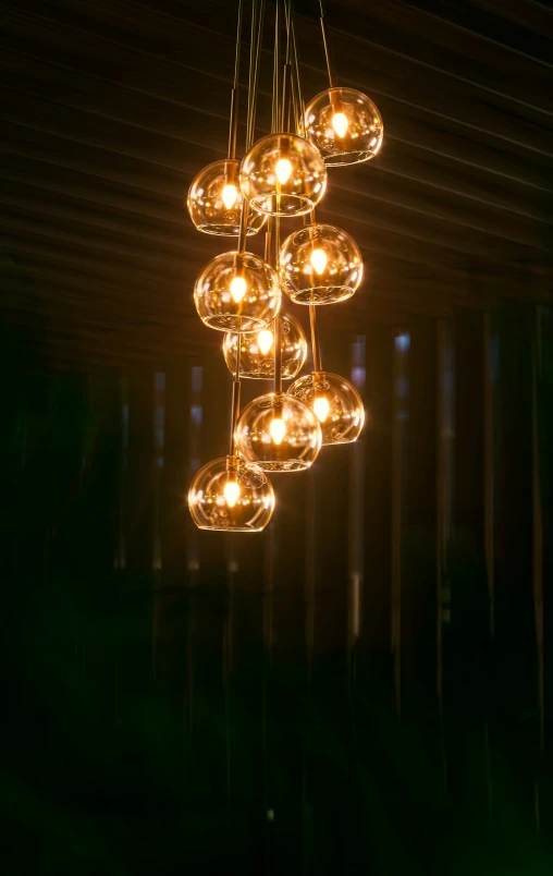 some light bulbs hanging from the ceiling and in the dark