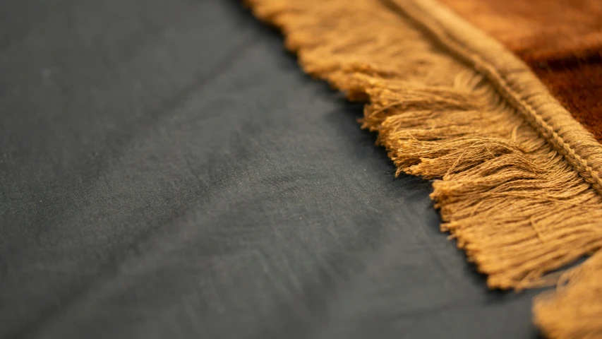 a close up of a black and tan area rug