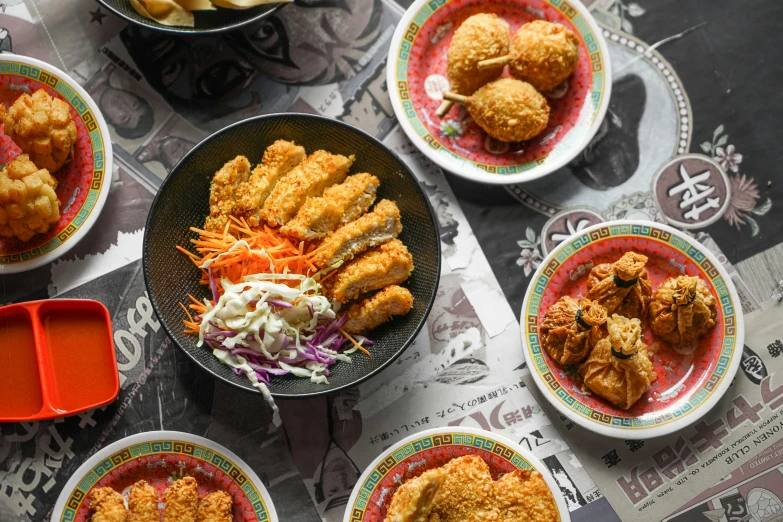 bowls of food on the table with sauce and chicken