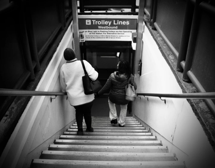 a couple of people standing on top of some stairs