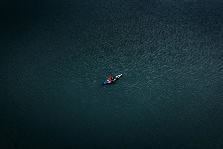 a person in a boat on water looking up