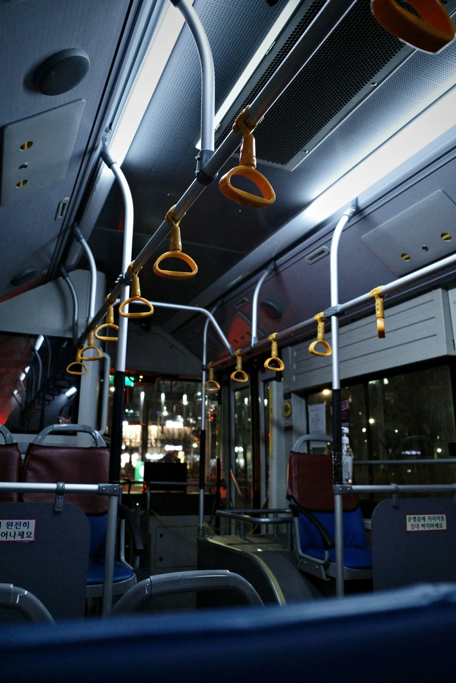 an empty metro bus with seats and a large fan