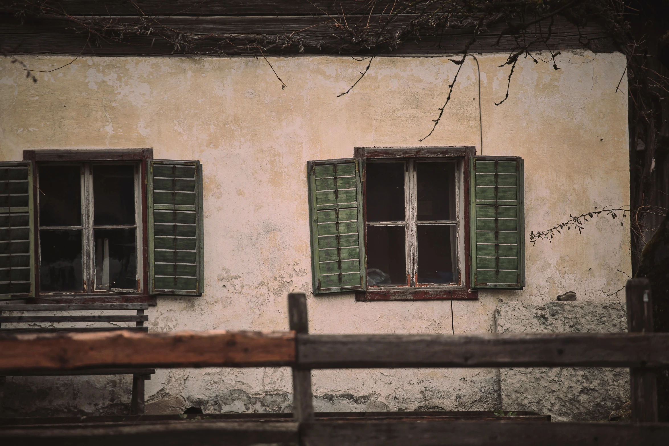 an old building with green windows and shutters