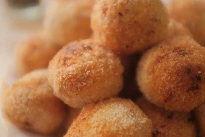 several pieces of breaded balls on a surface