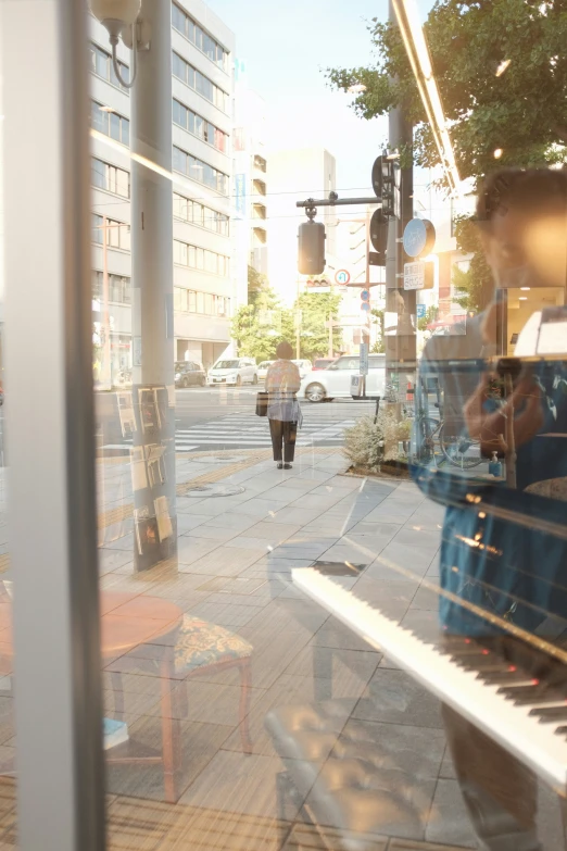 a woman walking by on the street with a suitcase