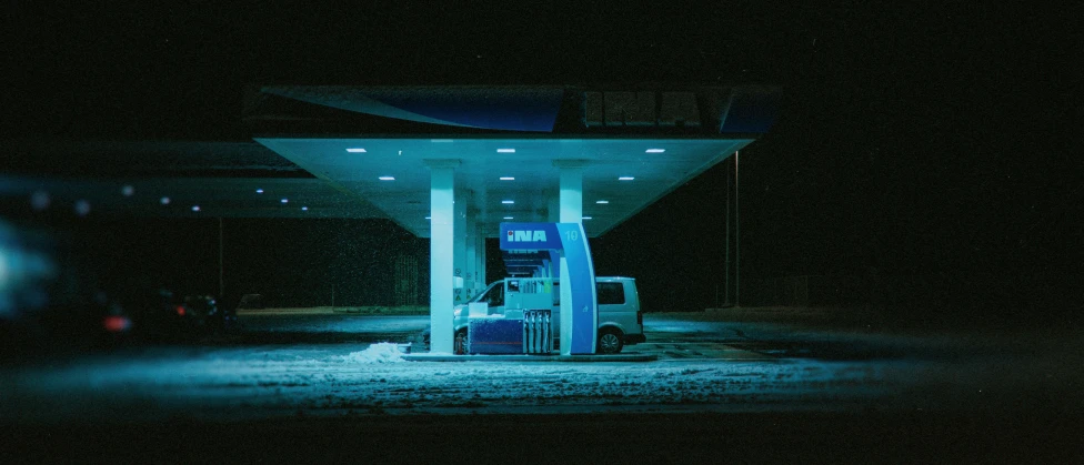 an gas station at night with blue lighting