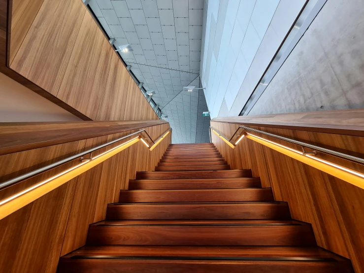 a flight of stairs in a building with wood paneling