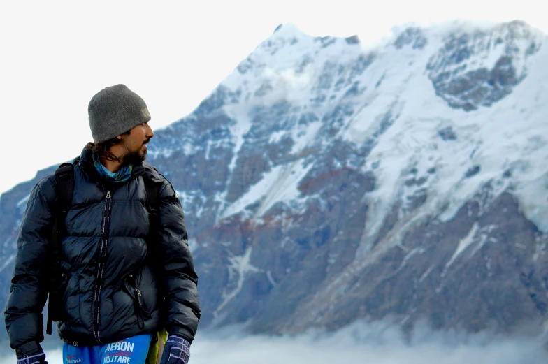 a man stands in front of the mountain