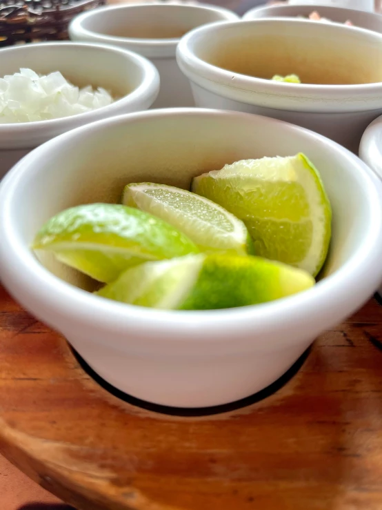 a bunch of bowls filled with different types of fruits