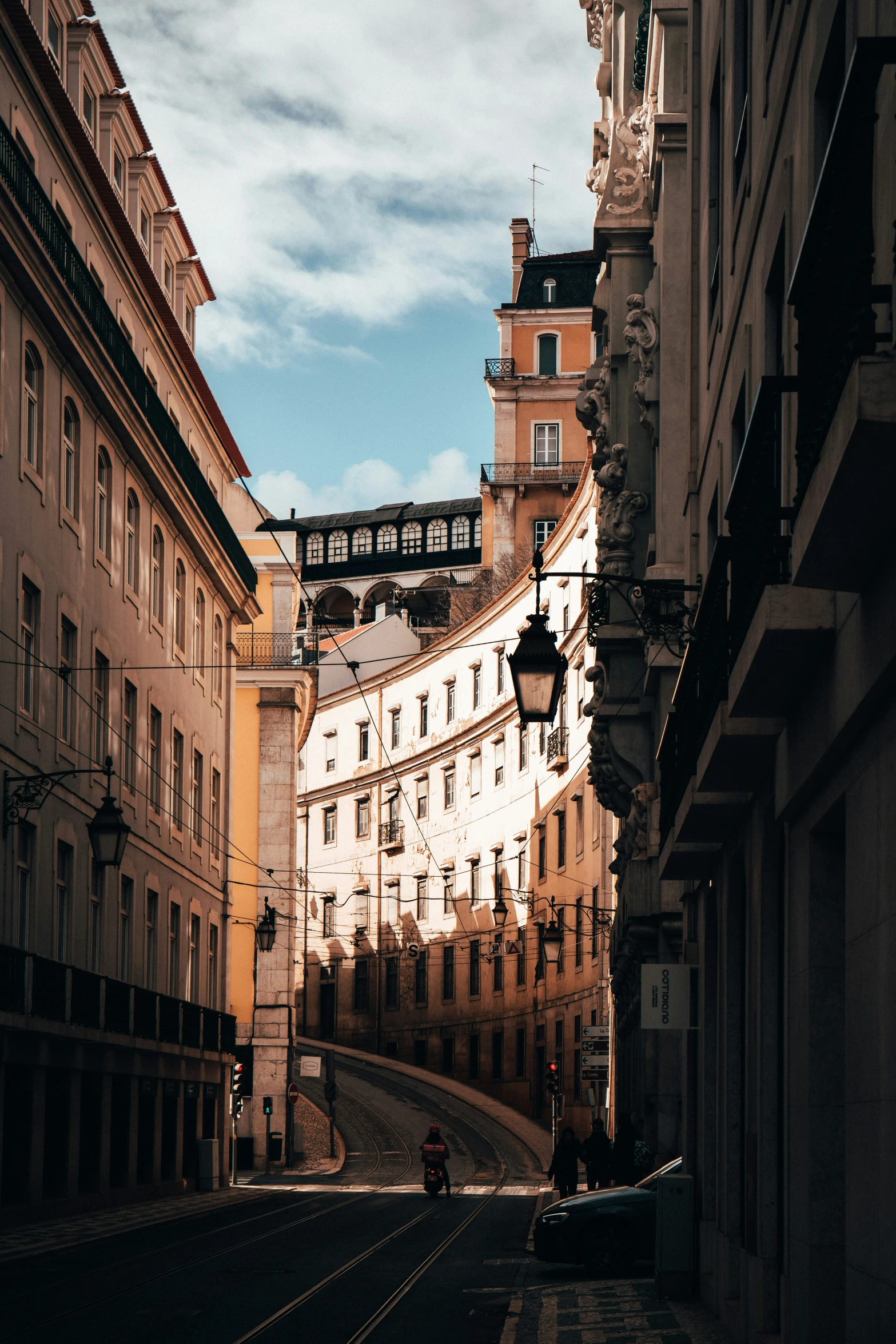 a narrow road surrounded by tall buildings