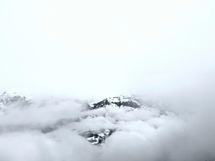 the sky is filled with fluffy clouds, with mountains in the distance