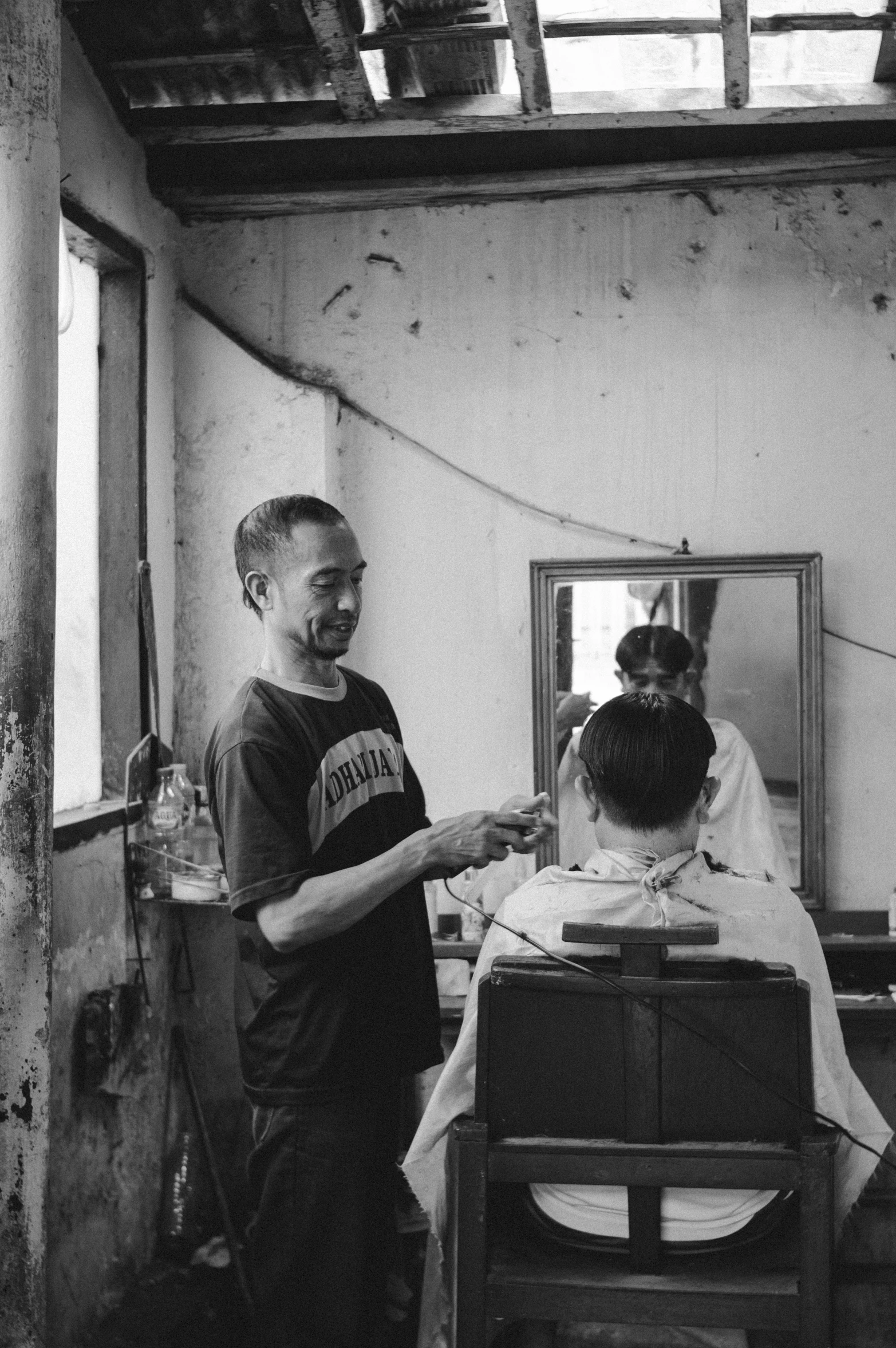 a man getting his hair cut by another man