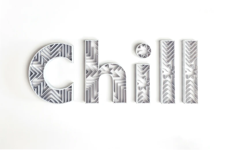 the word chill written in large metal type on white surface