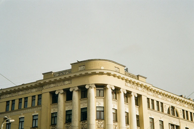 the building has pillars on each side and many windows