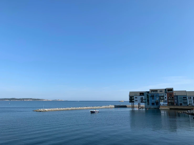 boats are on the water next to colorful homes