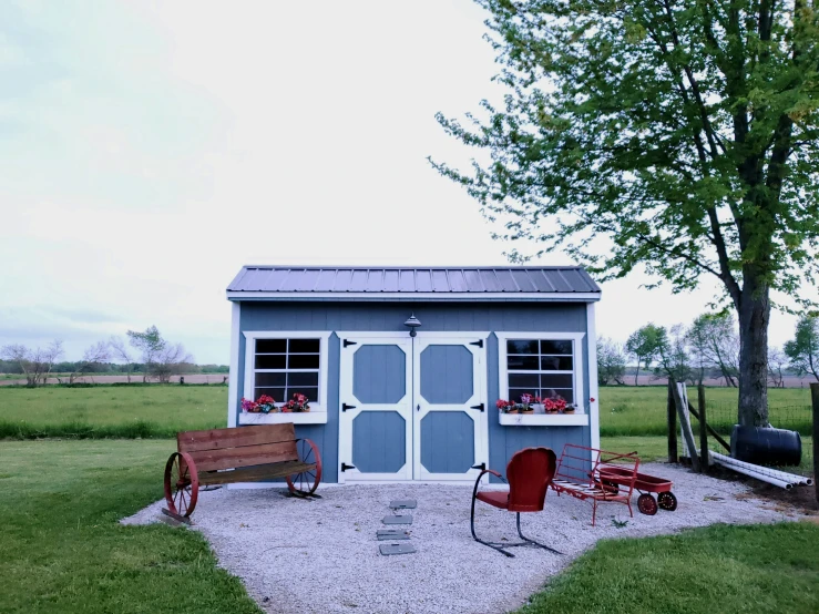 an outhouse is painted with windows and windows on the sides