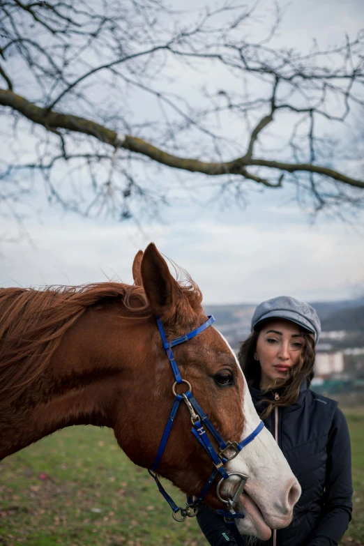 a woman in winter gear with a horse