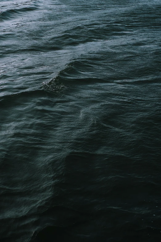 a man riding a surfboard on top of a wave