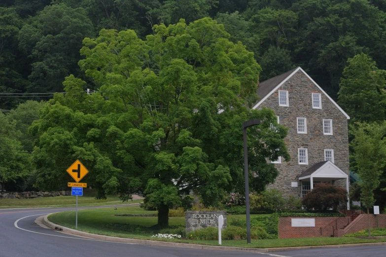 the treetops are full of green trees and a small house