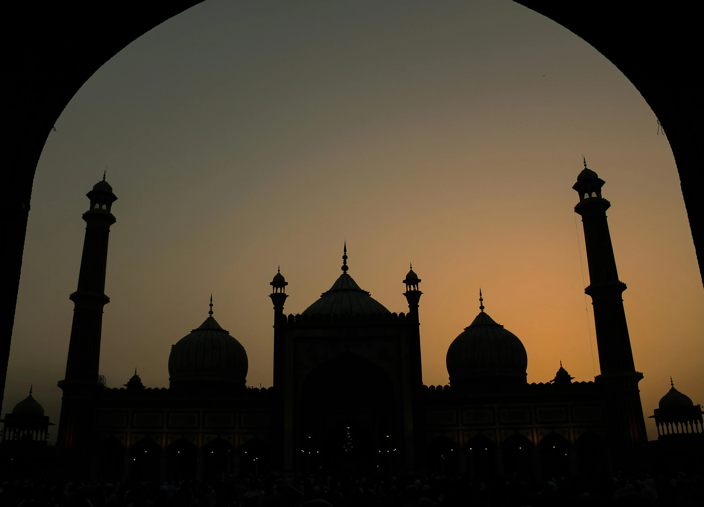 the silhouette of an old, historic building at sunset