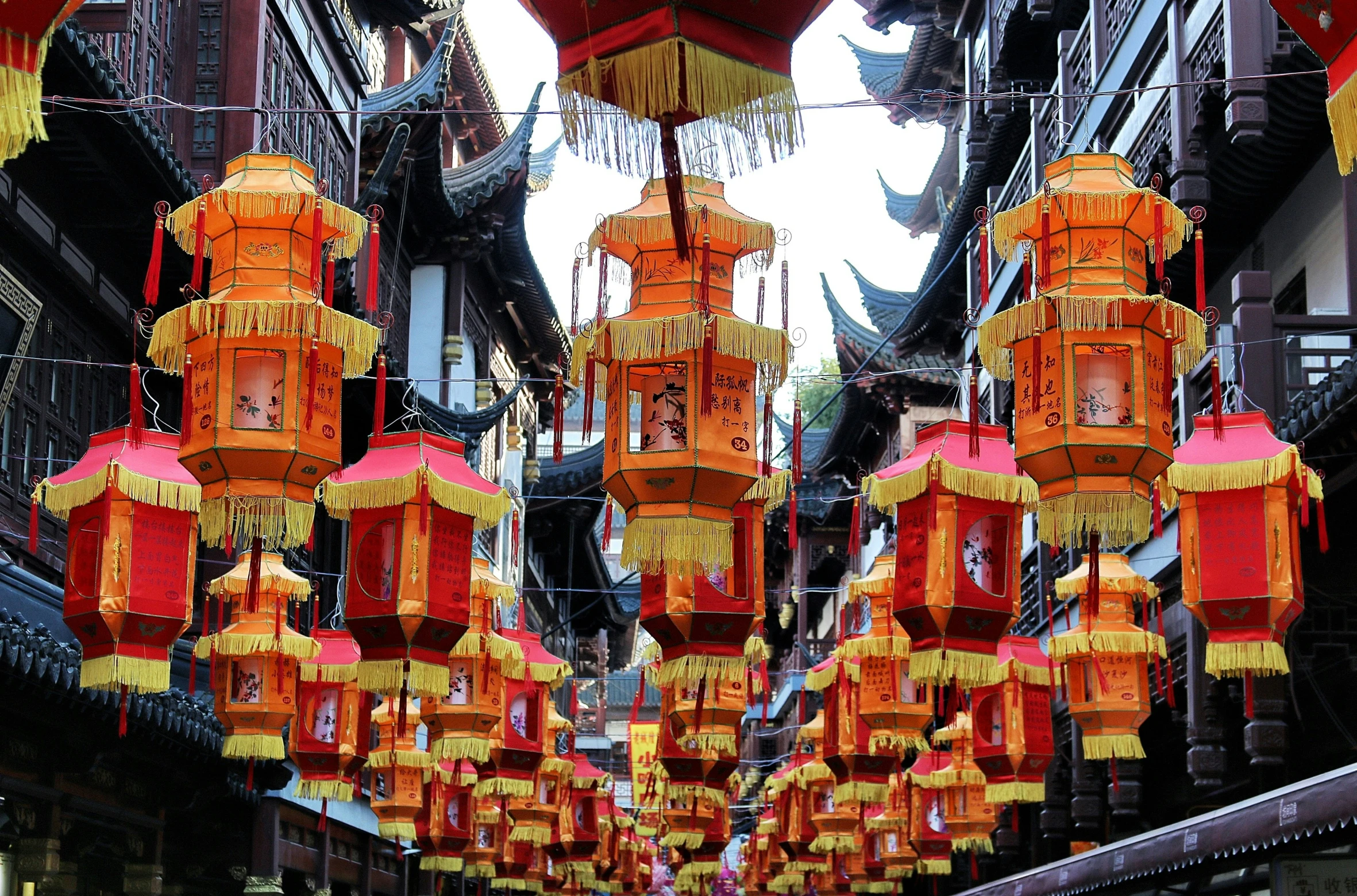 lots of red lamps in a very narrow city street