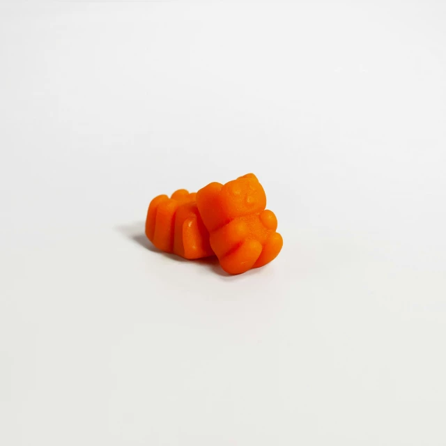 a group of sliced up orange carrots against a white background