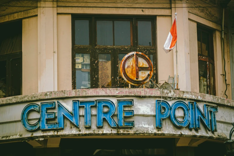 a building with a sign pointing towards the window of a store