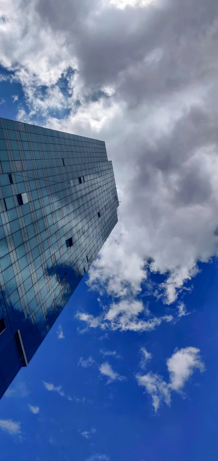 a skyscr in front of a cloudy blue sky