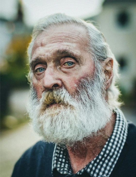 an old man with a white beard and a checkered shirt