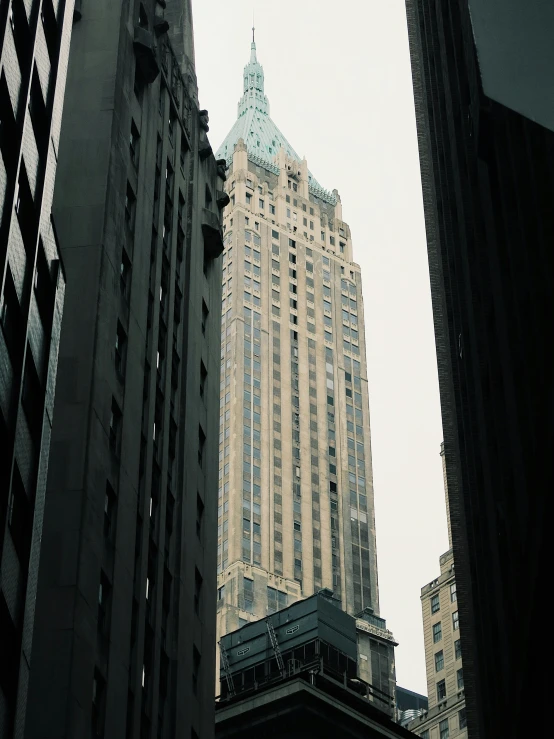 a clock on the tower of the skyscr