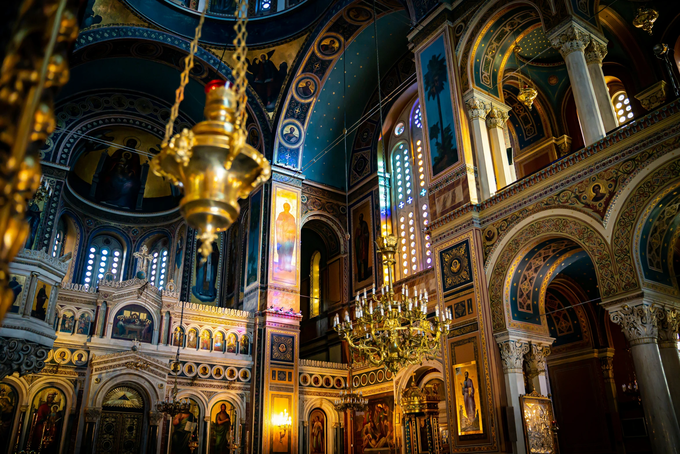 a large church with gold ornate ornaments and a chandelier