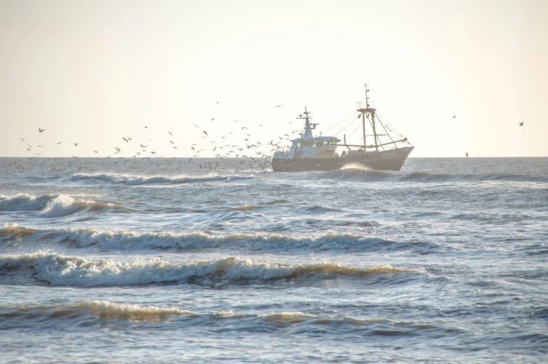 a large fishing boat moving through a choppy ocean