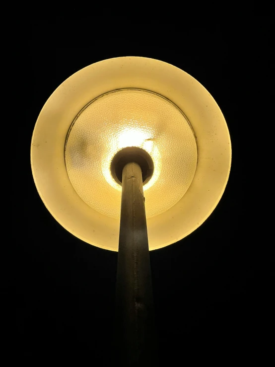 a lamp that is lit up against a dark sky