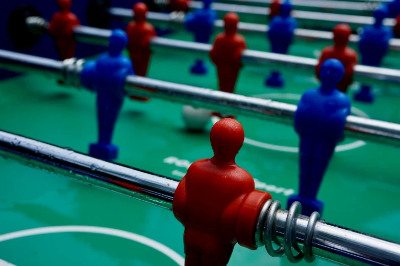 a foosball table with plastic blue and red people