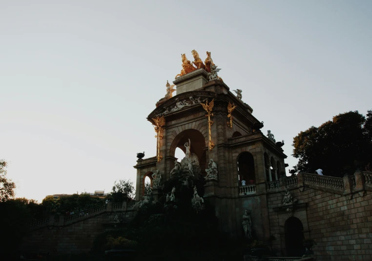 a stone building with lots of spires against a blue sky