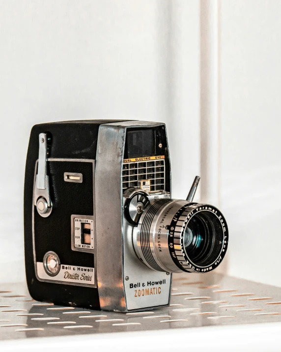 an old fashion camera is sitting on the shelf