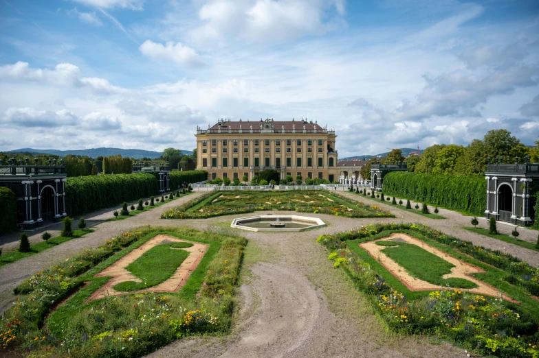 a view of a formal palace in the middle of a park