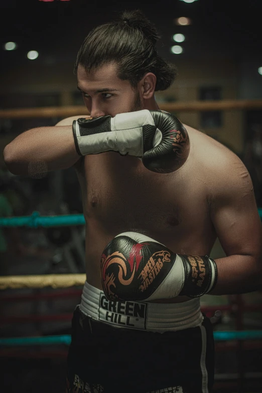 a young man with a tattooed arm in boxing gear